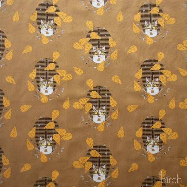 Birdwatcher organic cotton poplin fabric by Charley Harper for Birch Fabrics featuring a brown tabby cat among yellow leaves on a golden brown background.