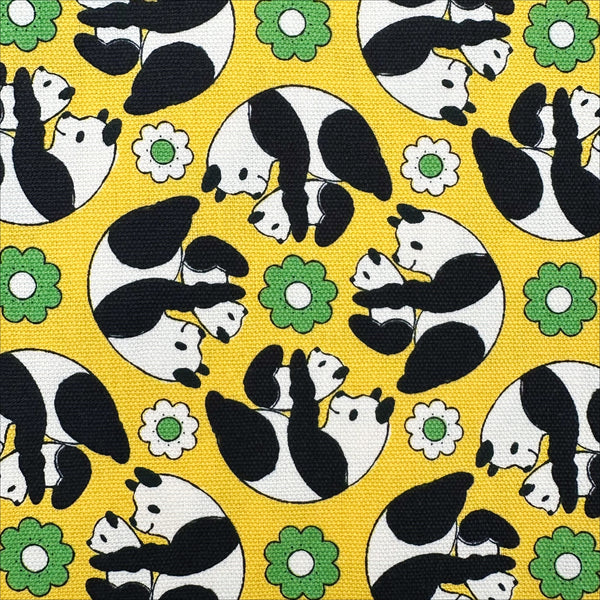 Close up of Goro Koro Panda Cotton Oxford Fabric in Yellow by Anyan for Cotorienne and Yuwa featuring adorable rolling pandas on a yellow background.