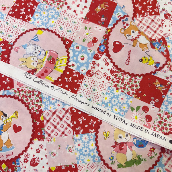 Selvage of Fancy Animal Circle Red cotton fabric from Atsuko Matsuyama Yuwa 30’s Collection, perfect for quilting and crafts.