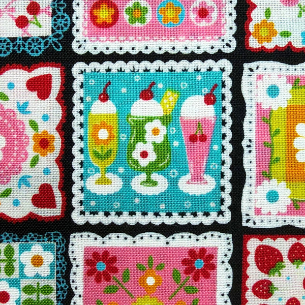 Close up of Sweet Treat Patchwork cotton fabric in black