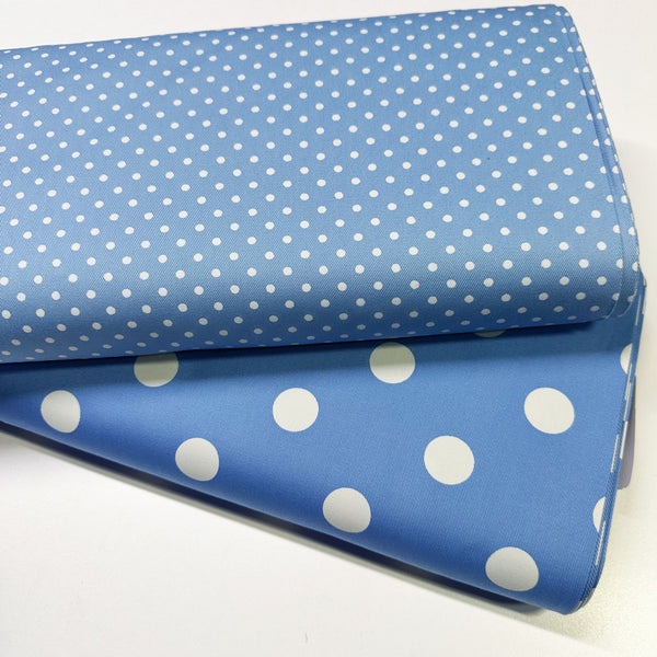 Bolts of medium polka dot blue cotton twill fabric by Sevenberry