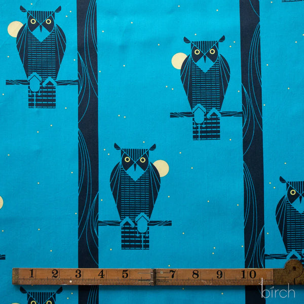 Scale of Moon Owl organic cotton poplin fabric by Charley Harper for Birch Fabrics featuring a black owl perched on a branch against a rich blue background.