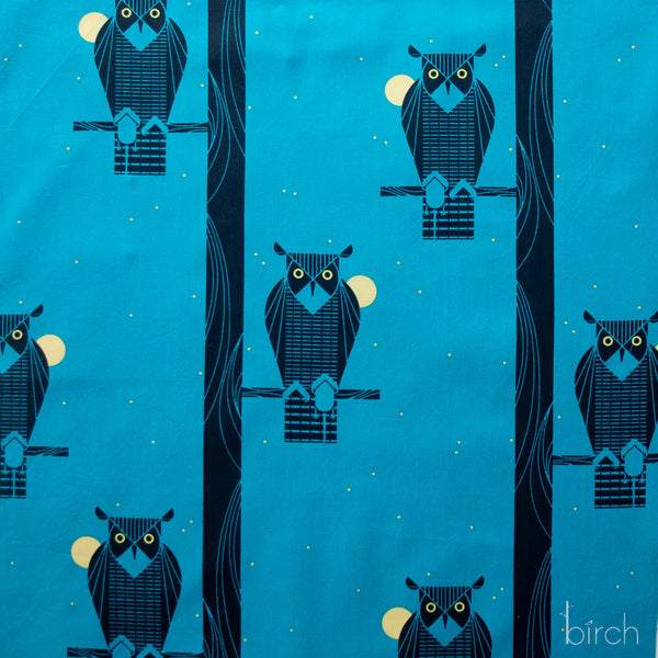 Moon Owl organic cotton poplin fabric by Charley Harper for Birch Fabrics featuring a black owl perched on a branch against a rich blue background.