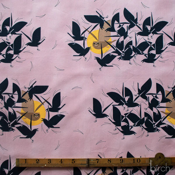 Scale of Owltercation organic cotton poplin fabric by Charley Harper for Birch Fabrics featuring an owl and blackbirds on a muted dusky mauve background.