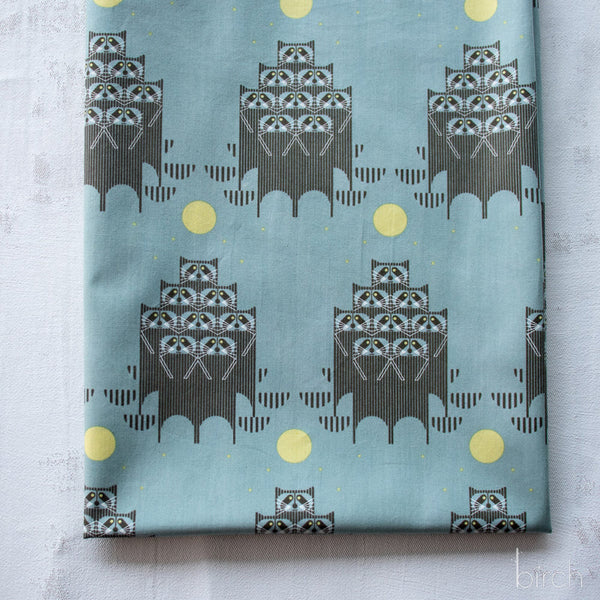 Raccpack organic cotton poplin fabric by Charley Harper for Birch Fabrics featuring raccoons in the moonlight on a dusky teal background.