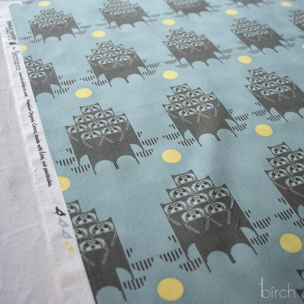 Selvage of Raccpack organic cotton poplin fabric by Charley Harper for Birch Fabrics featuring raccoons in the moonlight on a dusky teal background.