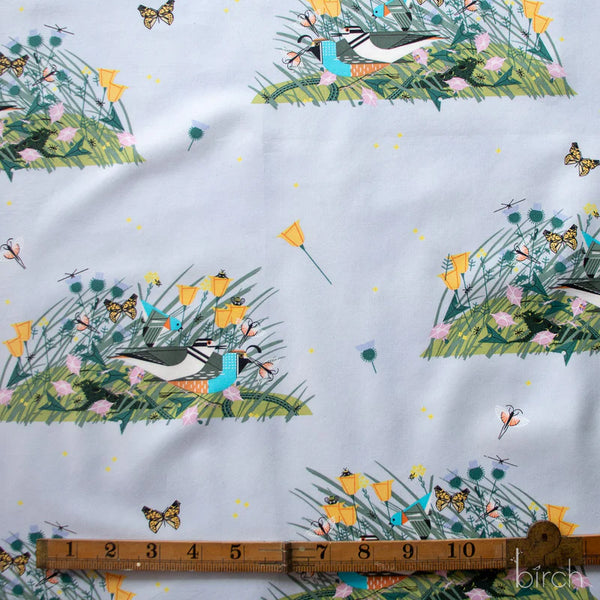 Small Once There Was A Field organic cotton poplin fabric by Charley Harper for Birch Fabrics featuring birds, bugs, and blooms on a pale blue background.