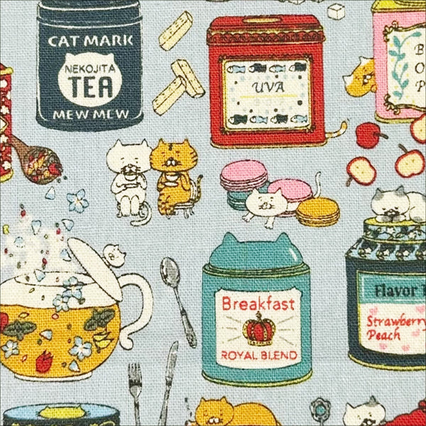 Close up of Tea Cats Canvas Fabric in Blue by Cotton Kobayashi – silly cats playing and drinking tea on cotton linen canvas, imported from Japan