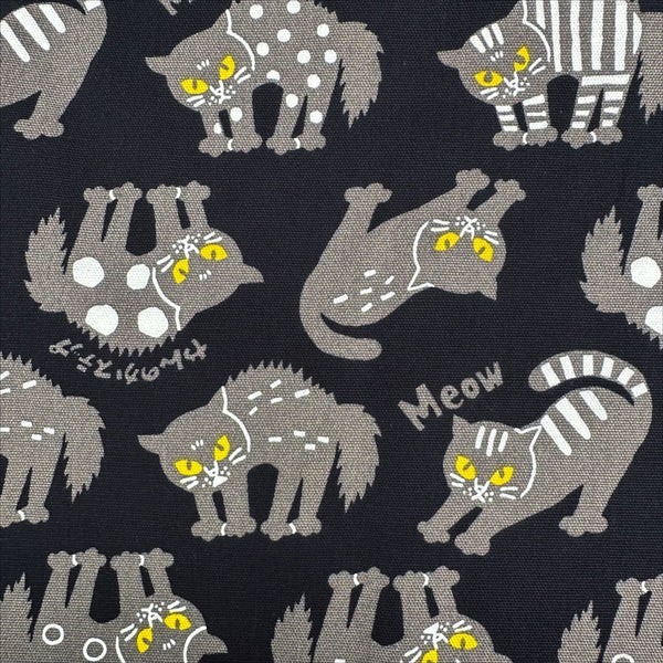 CLose up of Angry Cats Cotton Oxford Fabric in Black by Cosmo Textiles featuring black cats in a Halloween cat pose with arched backs and raised fur.