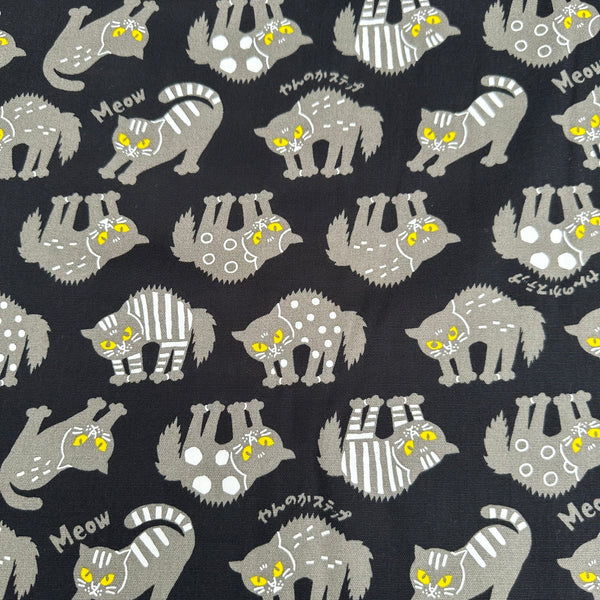 Angry Cats Cotton Oxford Fabric in Black by Cosmo Textiles featuring black cats in a Halloween cat pose with arched backs and raised fur.