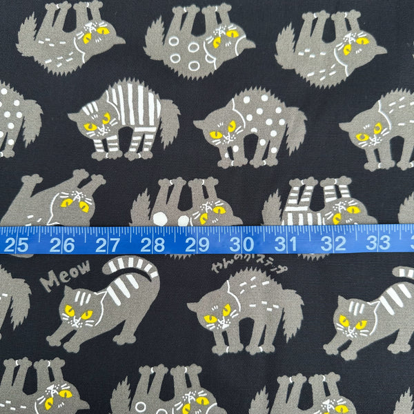 Scale of Angry Cats Cotton Oxford Fabric in Black by Cosmo Textiles featuring black cats in a Halloween cat pose with arched backs and raised fur.
