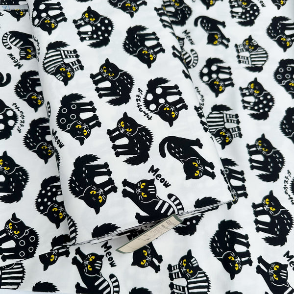 Bolt of Angry Cats Cotton Oxford Fabric in White by Cosmo Textiles featuring black cats in a Halloween cat pose with arched backs and raised fur.