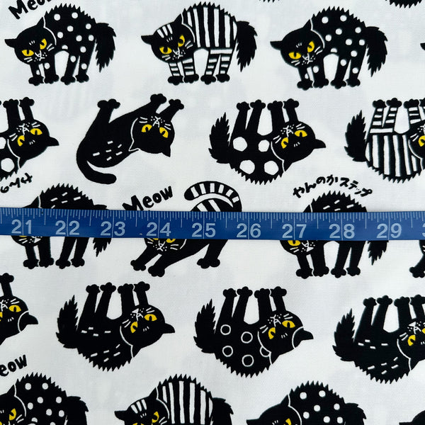 Scale of Angry Cats Cotton Oxford Fabric in White by Cosmo Textiles featuring black cats in a Halloween cat pose with arched backs and raised fur.