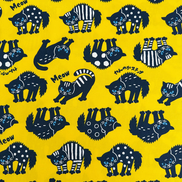 Angry Cats Cotton Oxford Fabric in Yellow by Cosmo Textiles featuring black cats in a Halloween cat pose with arched backs and raised fur.