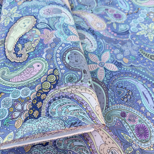bolt of Animal Paisley cotton fabric in Periwinkle by Nora featuring animal motifs nestled within an intricate paisley design, imported from Japan