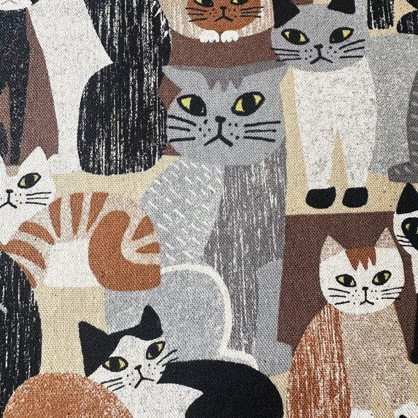 Close up of Art Animal Cats Cotton Linen Blend Canvas Fabric by Kokka, style YGA-91060 1D, featuring cat illustrations, in brown and multi