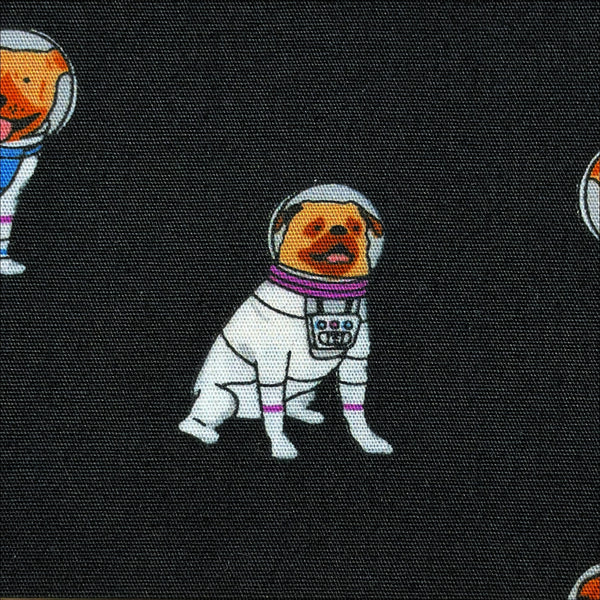 Close up of Astronaut Dogs cotton broadcloth fabric by Sevenberry in black