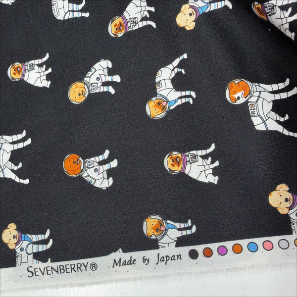 Selvage of Astronaut Dogs cotton broadcloth fabric by Sevenberry in black