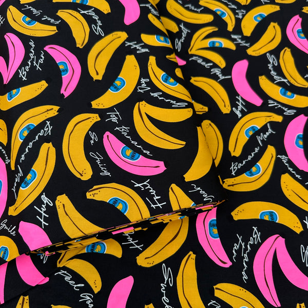 Bolt of Banana Mood cotton Oxford fabric in neon pink and black Japanese import fabric featuring a banana print