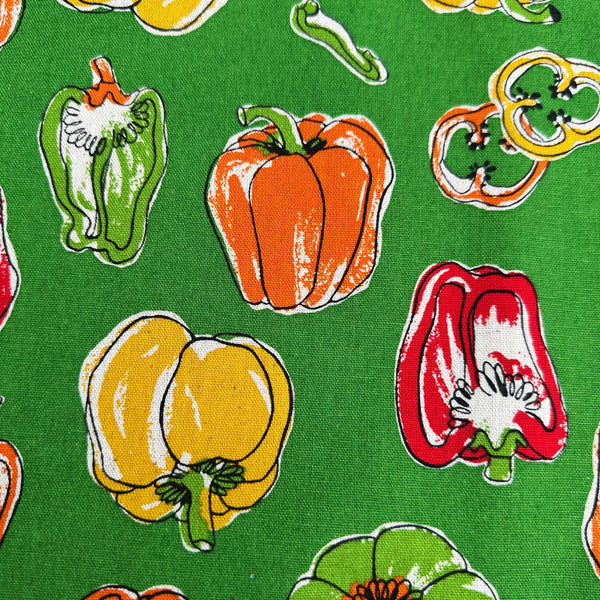 Close up of Bell Pepper Canvas Fabric by Cosmo Textiles, style AP62105-D, featuring bell pepper print, in green
