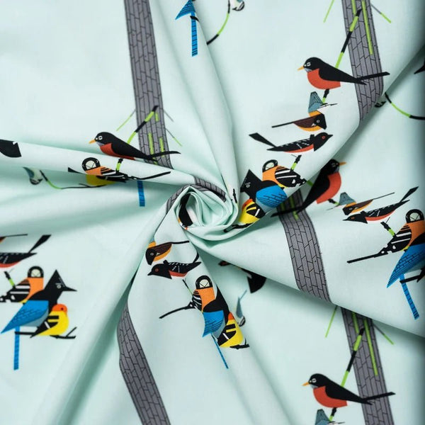 Drape of Birds on Pine Organic Poplin Fabric by Charley Harper for Birch Fabrics, style CH-164, featuring birds and pine trees, on pale blue background