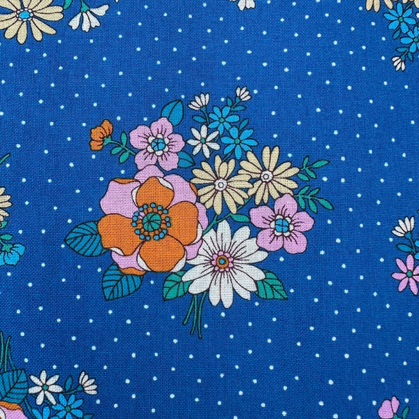Close up of Bloom Garland Retro Floral and Polka Dot Cotton Fabric by Koko Seki, in blue, imported from Japan