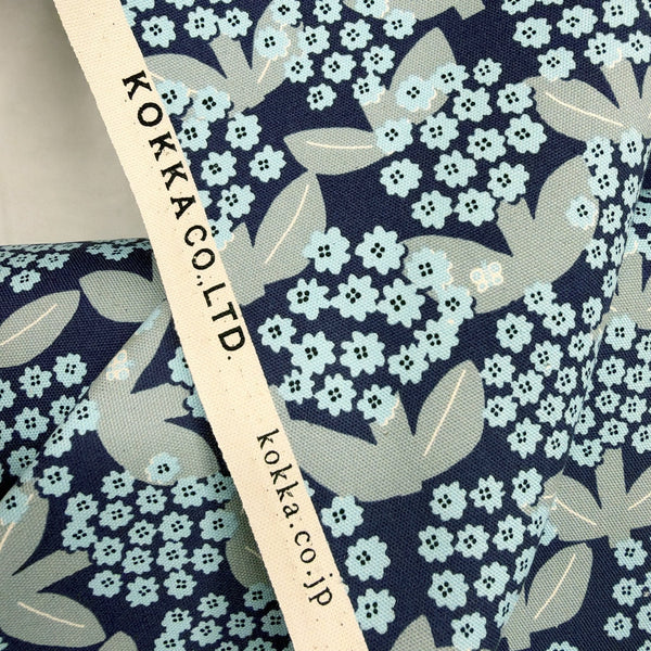 Selvage of Blooming Day cotton oxford fabric by Kokka in navy, YKA-41050-1E