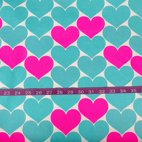 Scale of Bon Bon Heart cotton Oxford fabric in neon pink and aqua blue featuring a large-scale heart print, imported from Japan