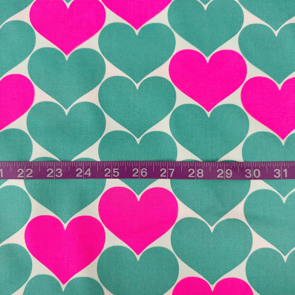 Scale of Bon Bon Heart cotton Oxford fabric in neon pink and green featuring a large-scale heart print, imported from Japan