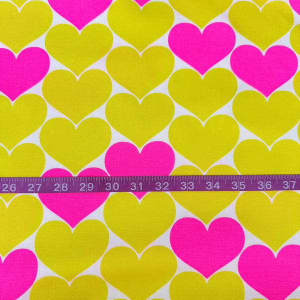 Scale of Bon Bon Heart cotton Oxford fabric in neon pink and yellow featuring a large-scale heart print, imported from Japan