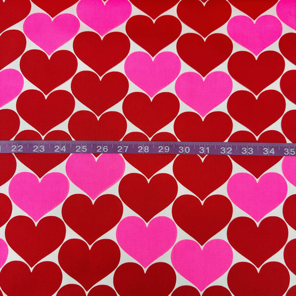 Scale of Bon Bon Heart cotton Oxford fabric in red and white featuring a large-scale heart print, imported from Japan
