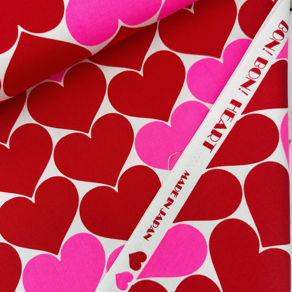 Selvage of Bon Bon Heart cotton Oxford fabric in red and white featuring a large-scale heart print, imported from Japan
