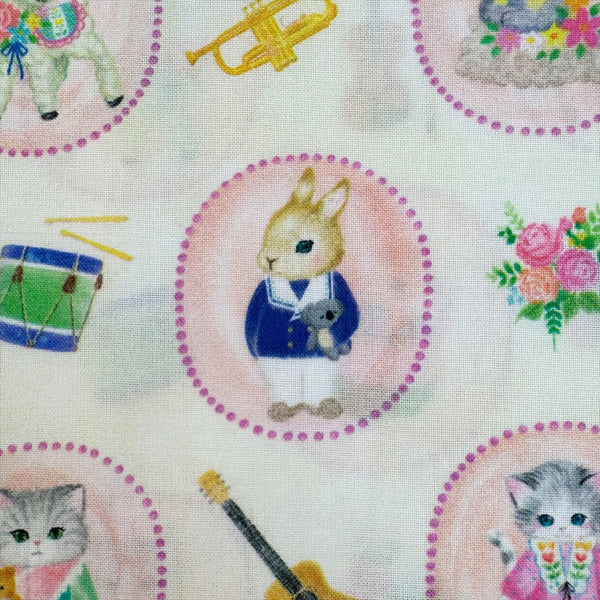 Close up bunny in Bon Bon Journey Cotton Lawn Fabric in Ivory by Yukiemon for Hokkoh featuring whimsical travel-themed illustrations on soft Japanese cotton lawn.