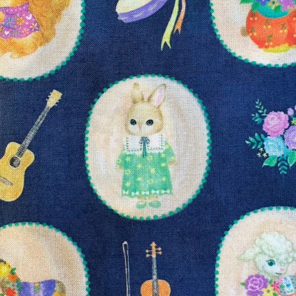 Close up of Bon Bon Journey Cotton Lawn Fabric in Navy by Yukiemon for Hokkoh featuring whimsical travel-themed illustrations on soft Japanese cotton lawn.