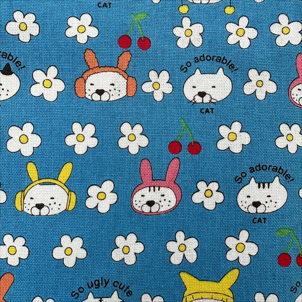 Close up of Bunny Cat cotton canvas fabric by Cotton Kobayashi in blue