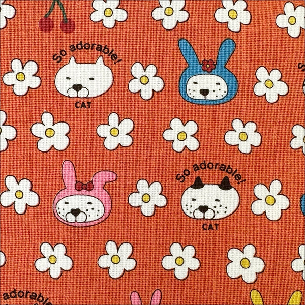 Close up of Bunny Cat cotton canvas fabric by Cotton Kobayashi in orange