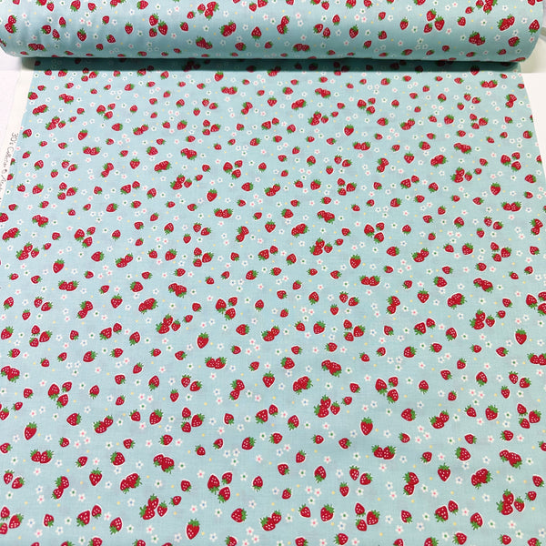 Bolt of Candy Berry blue cotton fabric with strawberry print from Atsuko Matsuyama Yuwa 30’s Collection, perfect for quilting and crafts.