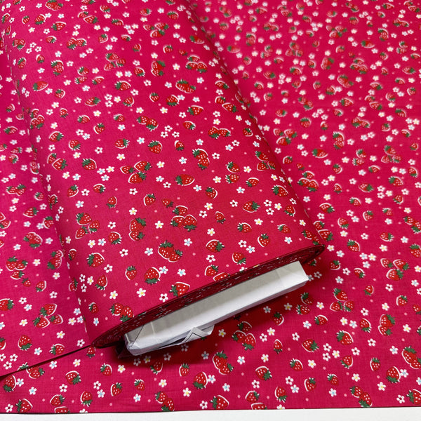Bolt of Candy Berry red cotton fabric with strawberry print from Atsuko Matsuyama Yuwa 30’s Collection, perfect for quilting and crafts.