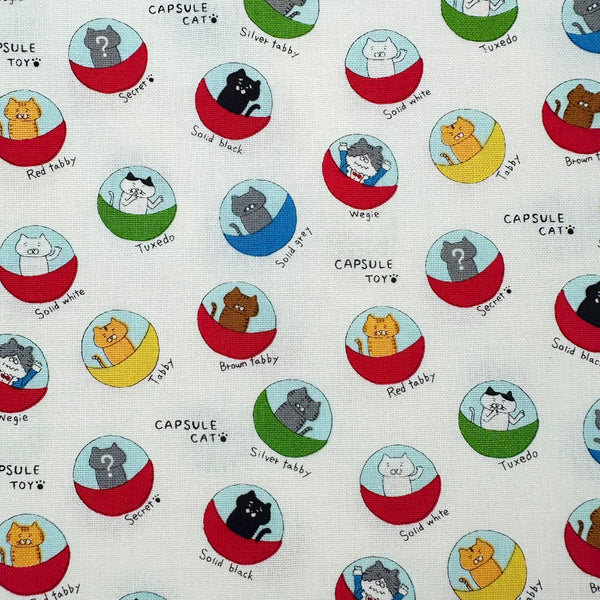 Capsule Toy Cats cotton canvas fabric in white by Cotton Kobayashi featuring playful cats inside capsule toy machines on a white background