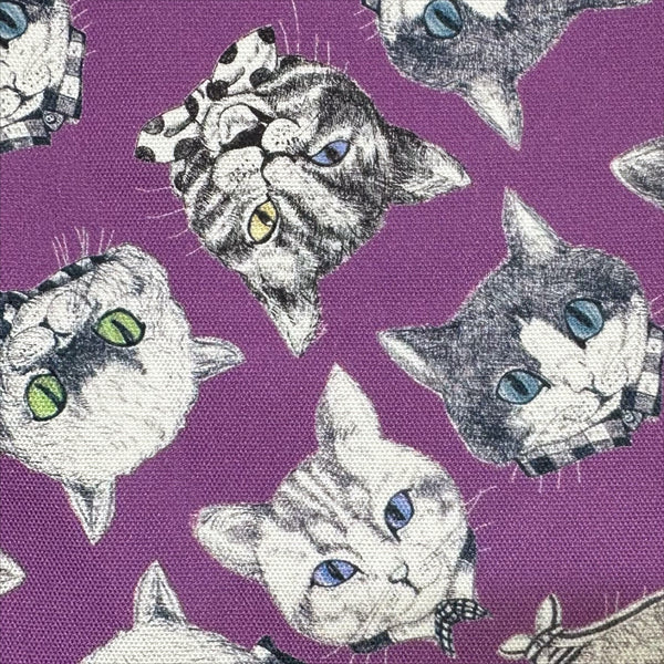 Close up of Cat Faces cotton oxford fabric in purple by illustrator Ringo, imported from Japan