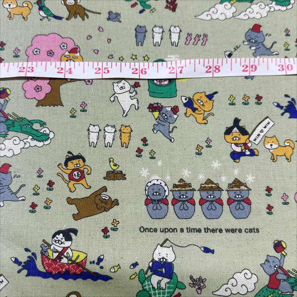 Scale of Cat Japanese Fairy Tale canvas fabric in light green by Cotton Kobayashi