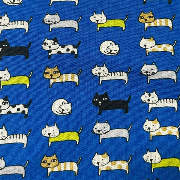 Close up of Cat Parade blue canvas fabric by Cotton Kobayashi, cotton linen blend with cat print