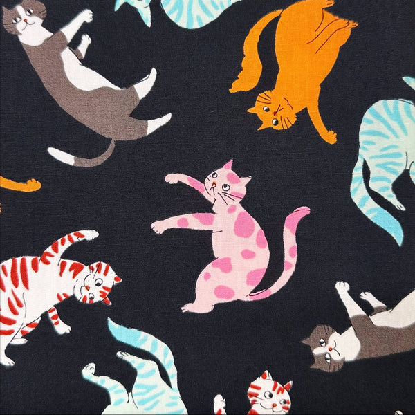 Close up of Cat Punch cotton broadcloth fabric in black by Sevenberry, Japanese import featuring playful cat print