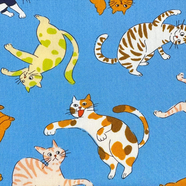 Close up of Cat Punch cotton broadcloth fabric in blue by Sevenberry, Japanese import featuring playful cat print