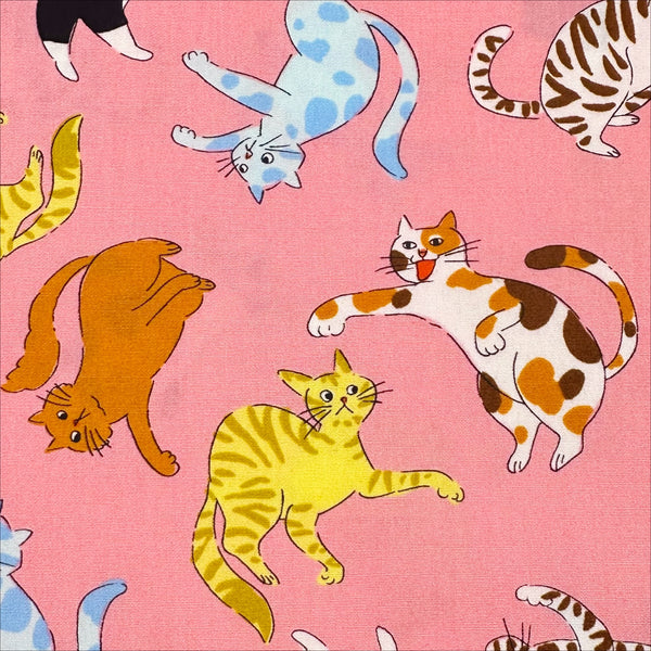 Close up of Cat Punch cotton broadcloth fabric in pink by Sevenberry, Japanese import featuring playful cat print