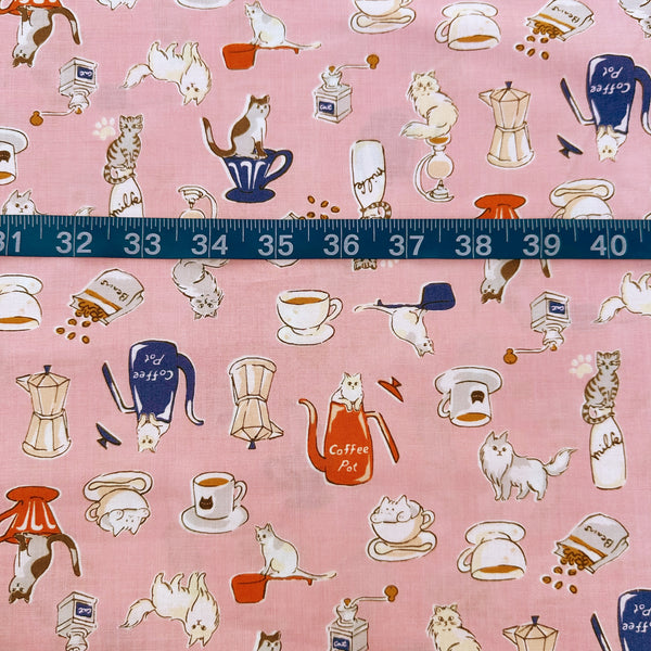Scale of Cat and Coffee cotton fabric by Handworks featuring playful cats and coffee-themed illustrations on a pink background