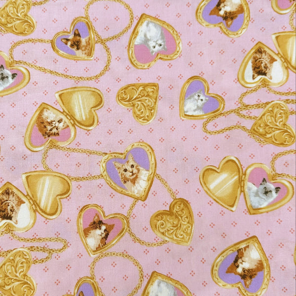 Cat Portrait Locket cotton fabric by Handworks featuring vintage-style cat portraits inside heart-shaped lockets on a pink background
