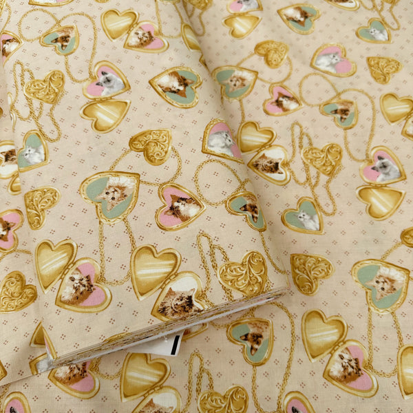 Bolt of Cat Portrait Locket cotton fabric by Handworks featuring vintage-style cat portraits inside heart-shaped lockets on a tan background