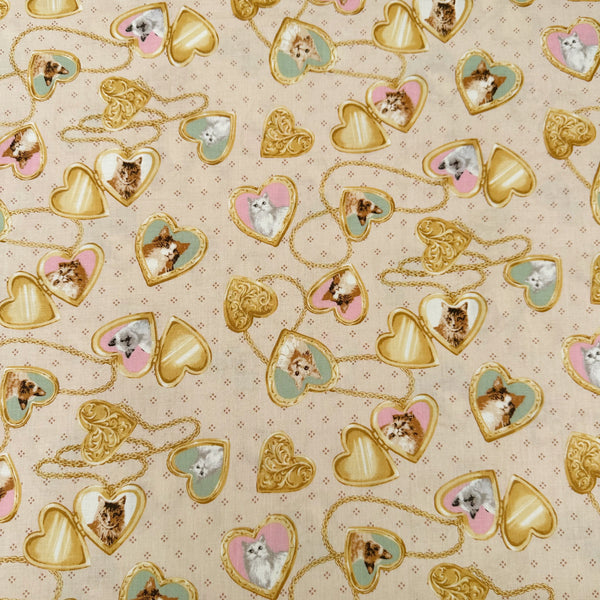 Cat Portrait Locket cotton fabric by Handworks featuring vintage-style cat portraits inside heart-shaped lockets on a tan background