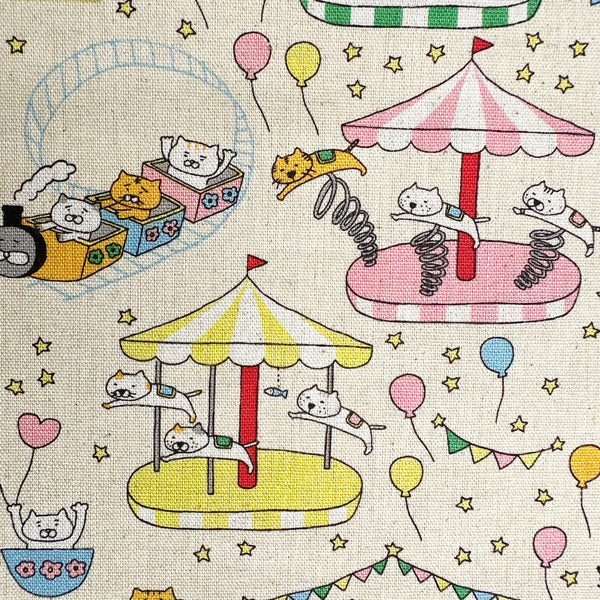 Close up of Catland Cotton Linen Canvas Fabric by Cotton Kobayashi, style KTS-7183A, featuring cats at an amusement park, in cream, imported from Japan